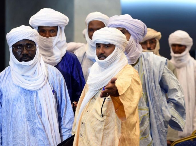 The vice president of the Tuareg National Movement for the Liberation of Azawad (MNLA), Mahamadou Djeri Maiga (C-L), arrives for a meeting on peace talks, attended by Mali's various warring factions for the first time since an interim agreement in June 2013, on July 16, 2014 in the Algerian capital Algiers. The Bamako government is ready to make concessions within its 'red lines' to clinch an accord with armed groups from northern Mali, Diop said, as peace talks began in Algiers. Those red lines include 'respect for territorial unity, the unity of Mali and the republican form of the Malian state,' he added. AFP PHOTO/FAROUK BATICHE