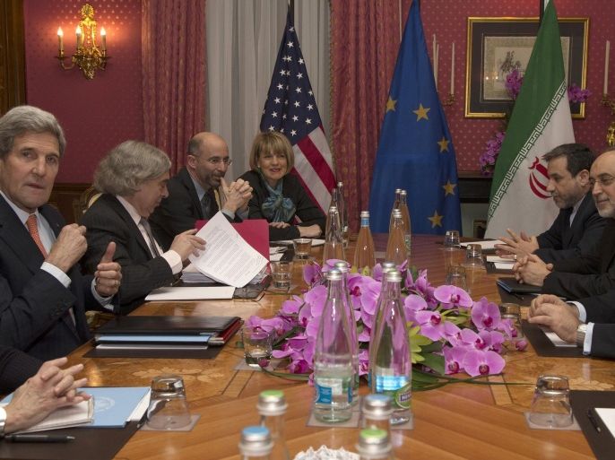 FILE - In this file photo dated Thursday, March 19, 2015, US Secretary of State John Kerry, left, holds a negotiation meeting with Iran's Foreign Minister Javad Zarif, seated opposite, over Iran's nuclear program, in Lausanne, Switzerland. (AP Photo/Brian Snyder, Pool, FILE)