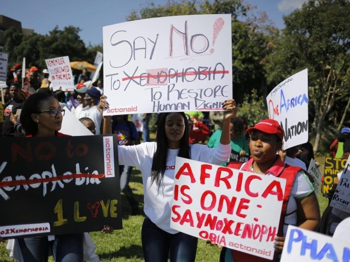 Some of the thousands of people are seen carrying anti xenophobia posters during a mass march calling for an end to attacks against foreign nationals, in Johannesburg, South Africa, 23 April 2015. Although the attacks of foreigners have stopped, thousands have been displaced and are living in refugees camps in Johannesburg and thousands of people have left South Africa to move back to their countries like Zimbabwe, Mozambique and Zambia.