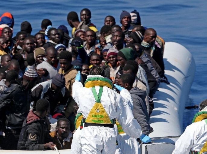In this photo made available Thursday, April 23, 2015, migrants crowd and inflatable dinghy as rescue vassel " Denaro " (not in picture) of the Italian Coast Guard approaches them, off the Libyan coast, in the Mediterranean Sea, Wednesday, April 22, 2015. European Union leaders gathering for an extraordinary summit are facing calls from all sides to take emergency action to save lives in the Mediterranean, where hundreds of migrants are missing and feared drowned in recent days. (Alessandro Di Meo/ANSA via AP Photo) ITALY OUT