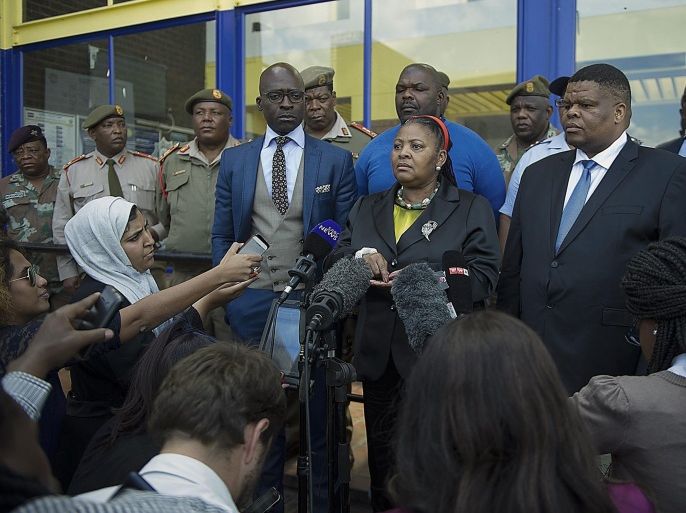 South Africa'S Defence Minister Nosiviwe Mapisa-Nqakula (C), addresses the media about the deployment of the military, in Alexandra Township in Johannesburg, on April 21, 2015. South African soldiers will be deployed to tackle gangs hunting down and killing foreigners, officials said on April 21, after at least seven people died in a wave of anti-immigrant violence. Police in the economic capital Johannesburg and in the port city of Durban have struggled to contain mobs who have targeted migrants from Zimbabwe, Malawi, Mozambique and other African countries over the last three weeks. AFP PHOTO / MUJAHID SAFODIEN