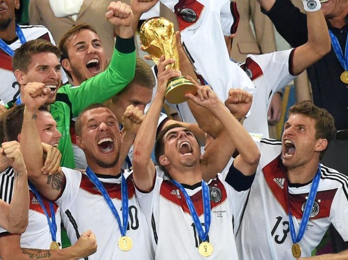 Philipp Lahm (C) of Germany lifts the World Cup trophy as his teammates Lukas Podolski (2-L) and Thomas Mueller (R) celebrate after the FIFA World Cup 2014 final between Germany and Argentina at the Estadio do Maracana in Rio de Janeiro, Brazil, 13 July 2014. Germany won 1-0 after extra time.(RESTRICTIONS APPLY: Editorial Use Only, not used in association with any commercial entity - Images must not be used in any form of alert service or push service of any kind including via mobile alert services, downloads to mobile devices or MMS messaging - Images must appear as still images and must not emulate match action video footage - No alteration is made to, and no text or image is superimposed over, any published image which: (a) intentionally obscures or removes a sponsor identification image; or (b) adds or overlays the commercial identification of any third party which is not officially associated with the FIFA World Cup) EPA/MARCUS BRANDT
