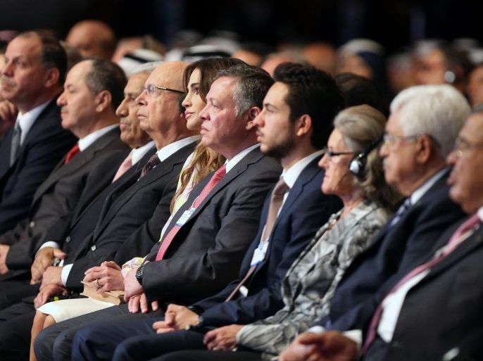 (In the center) Jordan's King Abdullah II, his wife Queen Rania and the founder and executive chairman of the World Economic Forum (WEF), German Klaus Schwab listen to speeches on the opening day of the WEF on the Middle East and North Africa 2015 on May 22, 2015 in the Dead Sea resort of Shuneh, west of the capital Jordanian Amman. AFP PHOTO / KHALIL MAZRAAWI