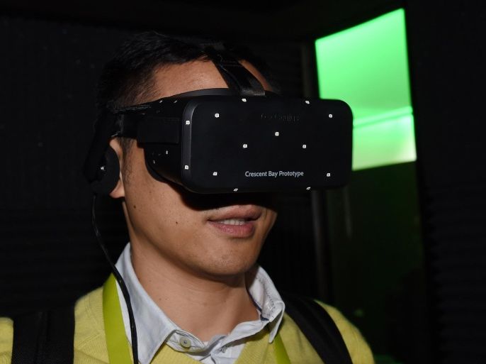 LAS VEGAS, NV - JANUARY 08: Bin Li of China tries out the Oculus VR Crescent Bay Headset prototype at the 2015 International CES at the Las Vegas Convention Center on January 8, 2015 in Las Vegas, Nevada. The immersive, virtual reality headset is meant to be a consumer version of the Oculus Rift and features 360-degree head tracking and high-quality integrated audio. CES, the world's largest annual consumer technology trade show, runs through January 9 and is expected to feature 3,600 exhibitors showing off their latest products and services to about 150,000 attendees.