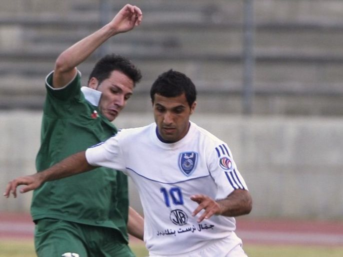 Ali El Atat (R) of Lebanon's Al Mabarrah fights for the ball with Ewerson Eduardo Moreira of Oman's Al Orouba during their Asian Cup qualifying soccer match in Beirut May 19, 2009.