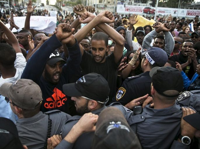 Protesters, mainly whom are Israeli Jews of Ethiopian origin, shout slogans during a demonstration against what they say is police racism and brutality, after the emergence last week of a video clip that showed policemen shoving and punching a black soldier during a protest in Tel Aviv May 3, 2015. Israeli mounted police charged hundreds of ethnic Ethiopian citizens and fired stun grenades on Saturday to try to clear one of the most violent protests in memory in the heart of Tel Aviv. REUTERS/Baz Ratner
