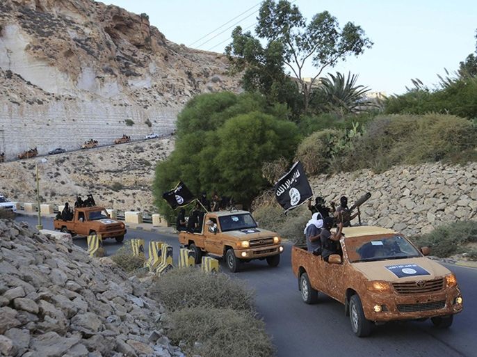 An armed motorcade belonging to members of Derna's Islamic Youth Council, consisting of former members of militias from the town of Derna, drive along a road in Derna, eastern Libya October 3, 2014. The group pledged allegiance to the Islamic State on October 3, 2014 local media reported. Picture taken October 3, 2014. REUTERS/Stringer (LIBYA - Tags: POLITICS CIVIL UNREST CONFLICT TPX IMAGES OF THE DAY)