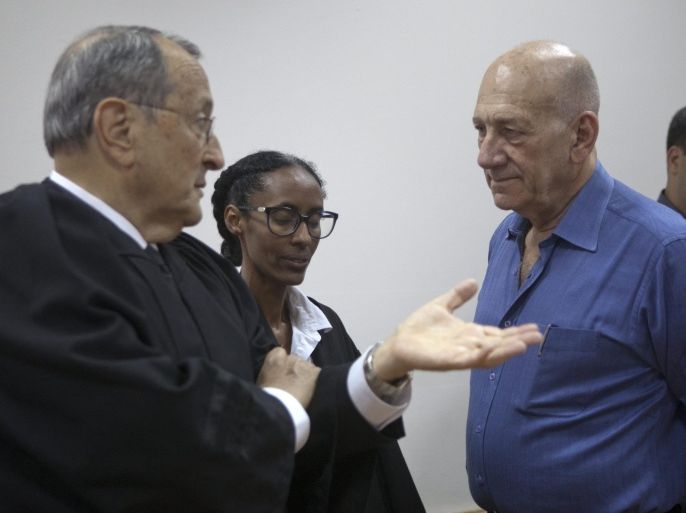 Former Israeli Prime Minister Ehud Olmert (R) with members of his defense team at the Jerusalem District Court, in Jerusalem, 25 May 2015. Olmert was handed an eight months prison sentence following his conviction for fraud and breach of trust in the Talansky affair. He was also fined 100,000 shekels (about 25,000 US dollars). Others are not identified.