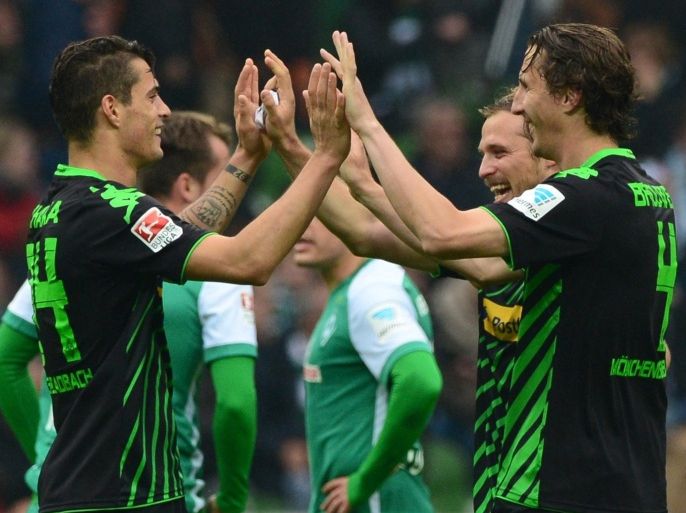 Moenchengladbach players celebrate after the German first division Bundesliga football match SV Werder Bremen vs Borussia Moenchengladbach in Bremen, northern Germany, on May 16, 2015. Moenchengladbach won 0-2. AFP PHOTO / JOHN MACDOUGALLRESTRICTIONS - DFL RULES TO LIMIT THE ONLINE USAGE DURING MATCH TIME TO 15 PICTURES PER MATCH. IMAGE SEQUENCES TO SIMULATE VIDEO IS NOT ALLOWED AT ANY TIME. FOR FURTHER QUERIES PLEASE CONTACT DFL DIRECTLY AT + 49 69 650050.