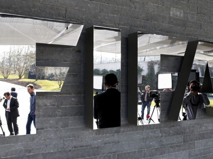 Journalists are reflected in the FIFA logo as they wait for a news conference after a meeting of the FIFA executive committee in Zurich March 20, 2015. REUTERS/Arnd Wiegmann