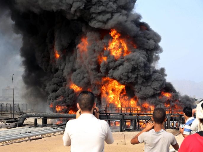 Black smoke rises from the burning crude oil tank at the Aden oil refinery after Houthi fighters attacked the refinery in the southern port city of Aden, Yemen, 27 June 2015. According to reports Houthis targeted the refinery with missiles, and have cut one of the last roads providing aid to non Houthi controlled areas in the city.