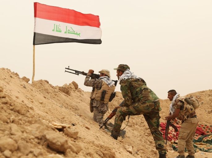Fighters from the Badr Brigades Shiite militia clash with Islamic State militant group at the front line, on the outskirts of Fallujah, Anbar province, Iraq, Monday, June 1, 2015. Three Islamic State suicide bombers targeted a police base in the Tharthar area north of Ramadi, some 30 miles (48 kilometers) west of Fallujah, with explosives-laden Humvees on Monday, killing at least 41 police and Shiite militiamen, officials said. (AP Photo/Hadi Mizban)