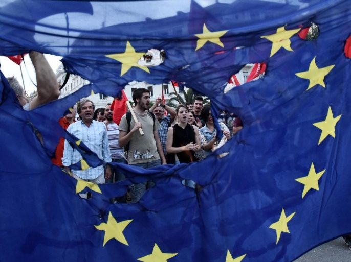Members of left wing parties burn a European Union flag during a protest in the northern Greek port city of Thessaloniki, Sunday, June 28, 2015.Greek Prime Minister Alexis Tsipras says the Bank of Greece has recommended that banks remain closed and restrictions be imposed on transactions, after the European Central Bank didn't increase the amount of emergency liquidity the lenders can access from the central bank. (AP Photo/Giannis Papanikos)