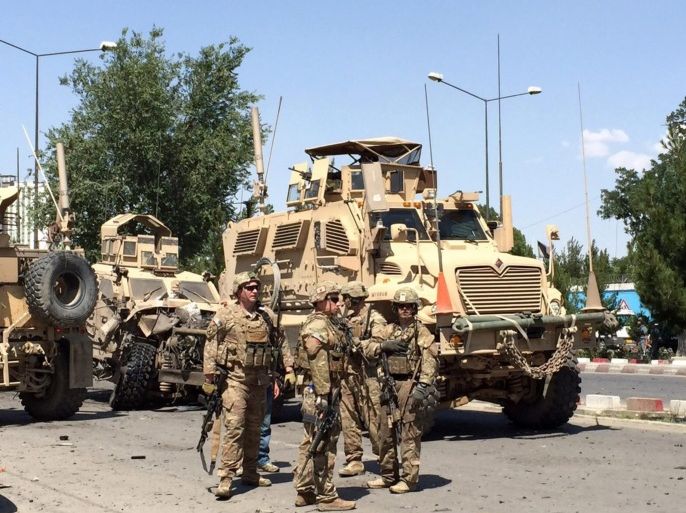NATO soldies stand guard near the site of a suicide bomb blast that targeted a convoy of foreign troops in Kabul, Afghanistan, 30 June 2015. A powerful explosion rocks Afghanistan's capital Kabul, a government official says. The incident occurred in a crowded place near the Supreme Court and hundreds meters away from the US Embassy, says Najib Danish, a spokesman for the Interior Ministry. Witnesses say that the target of the suicide bomber was a convoy of foreign troops.
