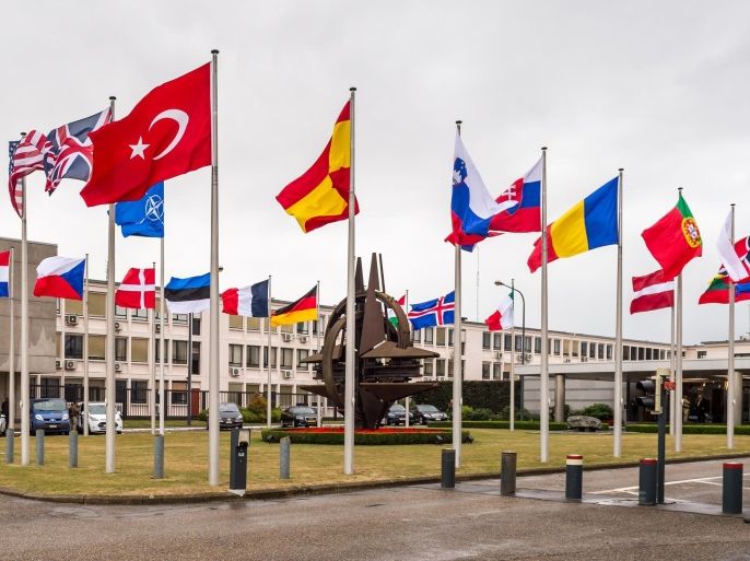 NATO country flags wave outside NATO headquarters in Brussels on Tuesday July 28, 2015. For just the fifth time in its 66-year history, NATO ambassadors met in emergency session Tuesday to gauge the threat the Islamic State extremist group poses to Turkey, and the debated actions Turkish authorities are taking in response. (AP Photo/Geert Vanden Wijngaert)