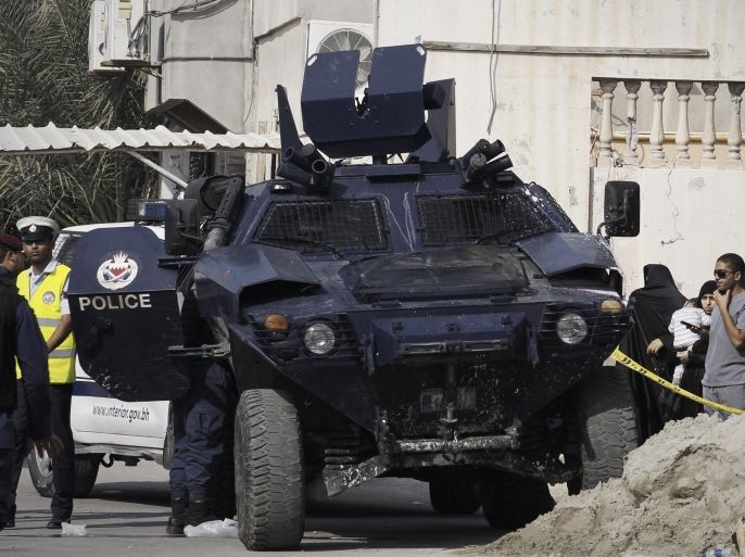 Bahraini police secure the site of a bomb blast that killed, Abdul Kareem Al Basri, 65, in the village of Karzakkan, south of Manama, on December 9, 2014. A bomb blast killed one person in a Shiite village in western Bahrain, according to the authorities, who have faced years of simmering unrest since crushing pro-democracy protests in 2011. AFP PHOTO/ MOHAMMED AL-SHAIKH