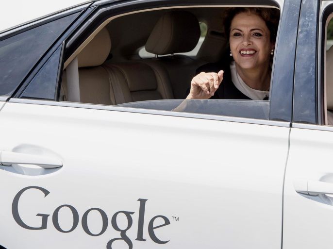 Dilma Rousseff, Brazil's president, waves from the back seat of a Google Inc. self driving car at the company's headquarters in Mountain View, California, U.S., on Wednesday, July 1, 2015. Brazil's real posted its first quarterly gain in a year as Rousseff made progress in winning political support for her effort to shore up fiscal accounts and preserve the nation's credit rating.