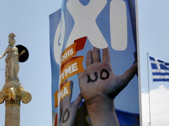 A "NO" referendum campaign poster is seen before a statue of Greek Godess Athena and a Greek flag outside the Athens Academy, Greece, July 4, 2015. With less than 24 hours to go until a referendum on the conditions of a new bailout deal, Greek officials prepare polling stations, as the latest opinion polls show 'Yes' and 'No' sides neck-and-neck. REUTERS/Yannis Behrakis