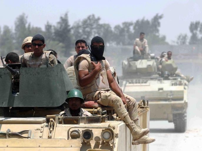 A picture made available 23 July 2015 shows members of the Egyptian armed forces in armoured vehicles patrolling a street near the town of Sheikh Zuweid, in the north of Sinai, Egypt, 13 July 2015. According to local reports 23 July four members of the Egyptian armed forces were killed when a roadside bomb exploded on a road near Rafah, to the east of Sheikh Zuweid. No group has claimed responsibility, however, hundreds of the armed forces have been killed as unrest continues in the peninsula.