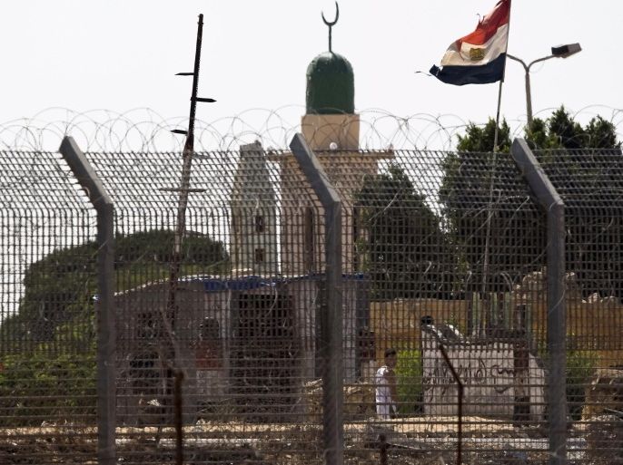 An Egyptian flag flutters near the border fence in North Sinai as seen from across the border in southern Israel July 2, 2015. Egypt launched air strikes on Islamist militant targets in the Sinai peninsula on Thursday, killing 23 fighters a day after the deadliest clashes in the region in years, security sources said. The sources said those killed had taken part in Wednesday's fighting in which 100 militants and 17 soldiers, including four officers, were killed, according to the army spokesman. REUTERS/Amir Cohen