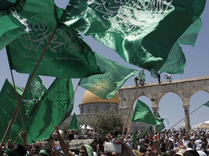 Palestinian Islamist Hamas supporters wave the faction's flag during a demonstration to mark Quds (Jerusalem) day following Friday prayer outside the Dome of the Rock mosque, at the al-Aqsa mosque compound, Islams third holiest site, in Jerusalem's old city on July 10, 2015 on the last Friday of the Islamic holy month of Ramadan. AFP PHOTO / AHMAD GHARABLI