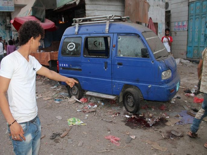 A Yemeni man points at a pool of blood at the site of rocket fire by Huthi Shiite rebels and their allies in Aden's loyalist-held al-Mansura district Aden on July 1, 2015. Rebel fire on a residential district of Yemen's second city Aden killed at least 20 civilians as loyalist forces in central city Taez launched a manhunt for 1,200 escaped prisoners. AFP PHOTO / SALEH AL-OBEIDI