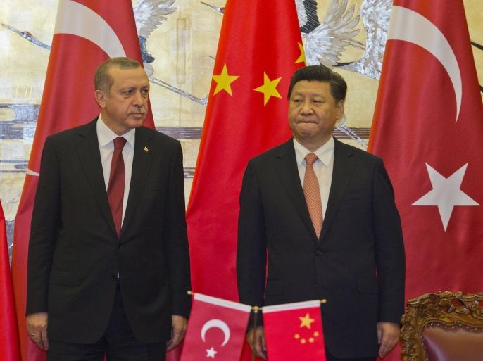 Turkey's President Recep Tayyip Erdogan, left, stands with Chinese President Xi Jinping during a signing ceremony at the Great Hall of the People in Beijing, Wednesday, July 29, 2015. Erdogan met with top Chinese officials Wednesday amid tensions over China's treatment of its Uighur minority and sensitive negotiations surrounding the possible purchase of a Chinese missile system. (AP Photo/Ng Han Guan, Pool)