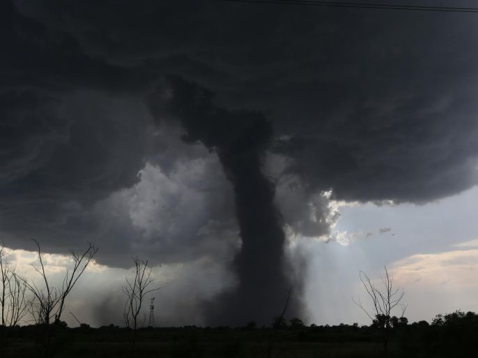 AP10ThingsToSee - A tornado builds and travels southwest causing damage near Dean Rd. and 82nd Avenue in Hutchinson, Kan. on Monday, July 13, 2015. (Sandra J. Milburn/The Hutchinson News via AP)