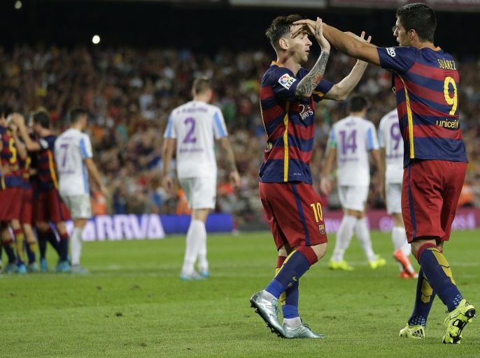 FC Barcelona's Lionel Messi, from Argentina, second right, celebrates with his teammate Luis Suarez, from Uruguay, after Thomas Vermaelen scored against Malaga during a Spanish La Liga soccer match at the Camp Nou stadium in Barcelona, Spain, Saturday, Aug. 29, 2015. (AP Photo/Manu Fernandez)