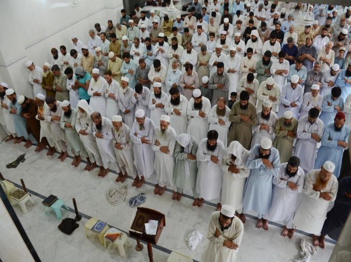People offer funeral prayers for Taliban leader Mullah Mohammad Omar at a mosque in Peshawar, Pakistan, Friday, July 31, 2015. Afghanistan's Taliban on Thursday confirmed the death of Mullah Omar, who led the group's self-styled Islamic emirate in the 1990s, sheltered al-Qaida through the 9/11 attacks and led a 14-year insurgency against U.S. and NATO troops. (AP Photo/Mohammad Sajjad)