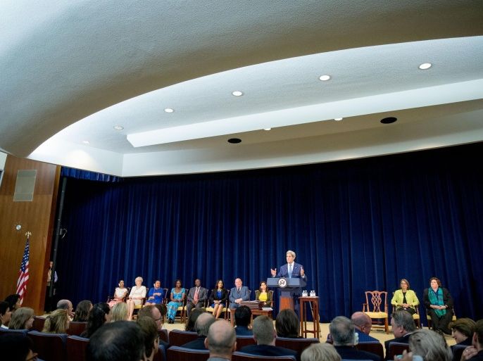 Secretary of State John Kerry, accompanied by eight "2015 Trafficking in Persons Report heroes" whose efforts have made an impact on the global fight against modern slavery, speaks during a news conference at the State Department in Washington, Monday, July 27, 2015, where he released the 2015 Trafficking in Persons Report. The State Department has taken Malaysia and Cuba off its blacklist of countries failing to combat modern-day slavery, leaving the U.S. open to criticism that politics is swaying the often-contentious rankings in its annual human trafficking report. (AP Photo/Andrew Harnik)