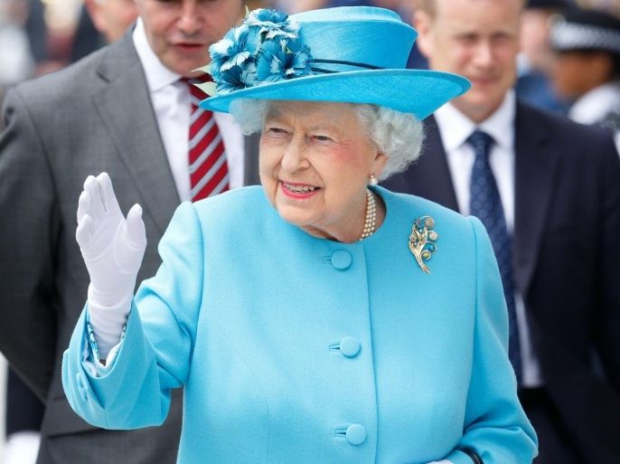 BARKING, UNITED KINGDOM - JULY 16: (EMBARGOED FOR PUBLICATION IN UK NEWSPAPERS UNTIL 48 HOURS AFTER CREATE DATE AND TIME) Queen Elizabeth II waves as she leaves the Broadway Theatre during a day of engagements in the London Borough of Barking and Dagenham on July 16, 2015 in Barking, England.
