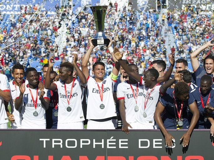 Paris Saint-Germain captain Thiago Silva, centre, along with teammates raise the Champions Trophy after defeating Olympique Lyonnais in Montreal, Saturday, Aug. 1, 2015. (Graham Hughes/The Canadian Press via AP)