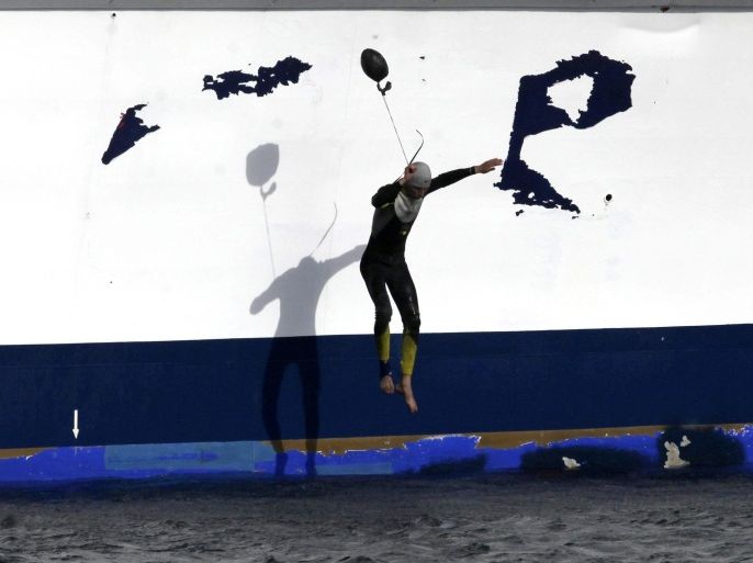 An illegal Moroccan immigrant jumps into the water from the ferry 'Detroit Jet' covering the Tangiers-Tarifa route, upon its arrival to Tarifa, in the southern province of Cadiz, Spain, 12 June 2014. A total of three immigrants were arrested by the authorities.