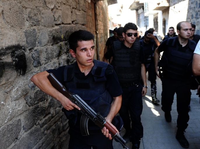 Turkish police officers conduct a security operation in Diyarbakir, southeastern Turkey, Saturday, Aug. 15, 2015. Turkey's state-run news agency says Kurdish rebels detonated a roadside bomb as a military vehicle was passing by, killing three soldiers. Anadolu Agency said six other soldiers were wounded in the attack on a highway between the eastern provinces of Bingol and Erzurum. The agency said the bomb was planted by the separatist Kurdistan Workers' Party, or PKK. (Usame Ari/Cihan News Agency via AP) TURKEY OUT