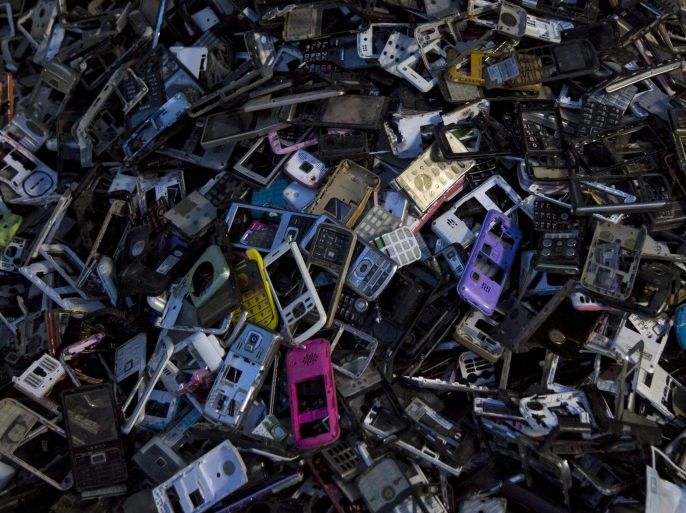 Old cellular phone components are discarded inside a workshop in the township of Guiyu in China's southern Guangdong province June 10, 2015. The town of Guiyu in the economic powerhouse of Guangdong province in China has long been known as one of the world’s largest electronic waste dump sites. At its peak, some 5,000 workshops in the village recycle 15,000 tonnes of waste daily including hard drives, mobile phones, computer screens and computers shipped in from across the world. Many of the workers, however, work in poorly ventilated workshops with little protective gear, prying open discarded electronics with their bare hands. Plastic circuit boards are also melted down to salvage bits of valuable metals such as gold, copper and aluminum. As a result, large amounts of pollutants, heavy metals and chemicals are released into the rivers nearby, severely contaminating local water supplies, devastating farm harvests and damaging the health of residents. The stench of burnt plastic envelops the small town of Guiyu, while some rivers are black with industrial effluent. According to research conducted by Southern China’s Shantou University, Guiyu’s air and water is heavily contaminated by toxic metal particles. As a result, children living there have abnormally high levels of lead in their blood, the study found. While most of the e-waste was once imported into China and processed in Guiyu, much more of the discarded e-waste now comes from within China as the country grows in affluence. China now produces 6.1 million metric tonnes of e-waste a year, according to the Ministry of Industry and Information Technology, second only to the U.S with 7.2 million tonnes. REUTERS/Tyrone Siu PICTURE 12 OF 18 FOR WIDER IMAGE STORY "WORLD'S LARGEST ELECTRONIC WASTE DUMP"SEARCH "GUIYU SIU" FOR ALL IMAGES