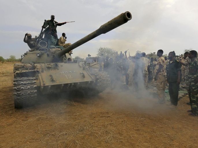Sudanese soldiers celebrate on a tank after recapturing the Daldako area, about 20 kilometres (12 miles) northeast of South Kordofan's state capital Kadugli, on May 20, 2014. Ethnic minority rebels have been fighting government forces for three years in a largely-hidden war which the UN says has affected more than one million people. AFP PHOTO /STR