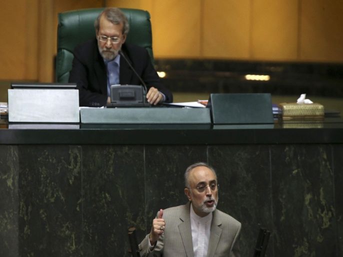 Chief of Iran's Atomic Energy Organization Ali Akbar Salehi, bottom, addresses parliament while speaker Ali Larijani listens in an open session of parliament in Tehran, Iran, Tuesday, July 21, 2015. Salehi on Tuesday briefed the lawmakers on a recent nuclear deal with world powers. (AP Photo/Vahid Salemi)