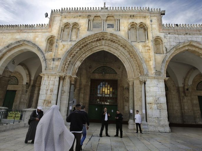A photograph released on 26 November 2014 shows Palestinian guardians at the entrance to the al-Aqsa Mosque on Hareem el-Sharif (The Noble Sanctuary, also knows as the Temple Mount), in Jerusalem's Old City as Moslem come and go to prayers at one of the holiest sites in the Islamic world, on 13 November 2014. Media reports on 26 November 2014 state that Israel will advance a law to ban the organisation of Palestinian guards stationed on the al-Aqsa compound, and known as the 'Mourabitoun,' to block entry to the sites from heretics.