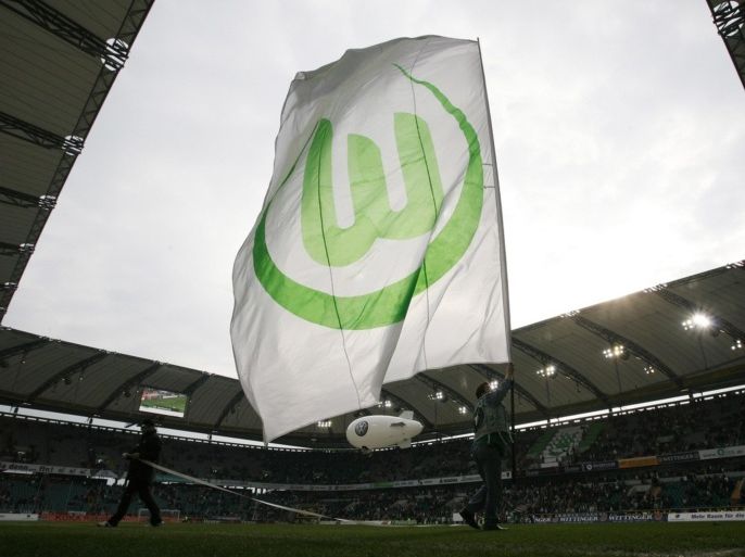 A supporter of VfL Wolfsburg waves a giant flag with the club logo following a German Bundesliga first division soccer match against Bayer 04 Leverkusen in Wolfsburg April 18, 2009. Wolfsburg won the match 2-1.