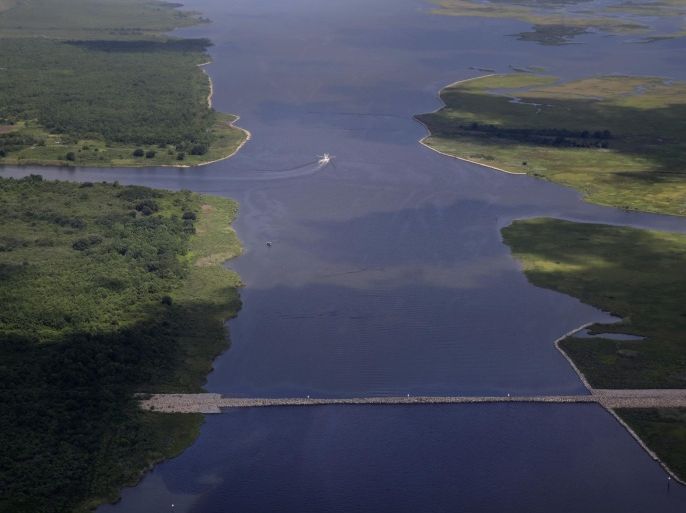 In this aerial photo made during a flight provided by the National Wildlife Federation and Southern Wings, a shrimp boat travels behind a rock dam built by the U.S. Army Corps of Engineers after Hurricane Katrina, in the Mississippi River Gulf Outlet (MRGO) in St. Bernard Parish, La., Monday, Aug. 10, 2015. The MRGO, originally built by the Corps, carried a storm surge from Katrina straight into the New Orleans area causing devastating flooding in the Parish. (AP Photo/Gerald Herbert)