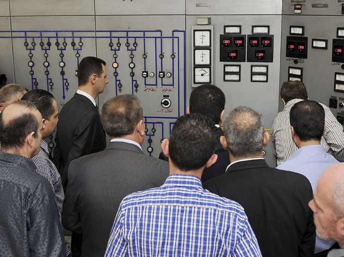 Syria's President Bashar al-Assad (front L) visits the Umawyeen electricity station at Tishreen park on May Day in Damascus May 1, 2013, in this handout photograph distributed by Syria's national news agency SANA. REUTERS/SANA/Handout (SYRIA - Tags: POLITICS BUSINESS EMPLOYMENT) NO SALES. NO ARCHIVES. ATTENTION EDITORS - THIS IMAGE WAS PROVIDED BY A THIRD PARTY. FOR EDITORIAL USE ONLY. NOT FOR SALE FOR MARKETING OR ADVERTISING CAMPAIGNS. THIS PICTURE IS DISTRIBUTED EXACTLY AS RECEIVED BY REUTERS, AS A SERVICE TO CLIENTS
