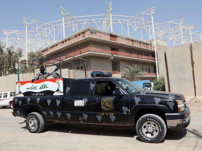 Iraqi security forces guard the entrance to a sports complex being built by a Turkish construction company, in the Shiite district of Sadr City, Baghdad, Iraq, Wednesday, Sept. 2, 2015. Masked men in military uniforms kidnapped 18 Turkish workers and engineers working at the site in Baghdad at dawn Wednesday, bundling them into several SUVs and speeding away, Iraqis security officials said. (AP Photo/Khalid Mohammed)