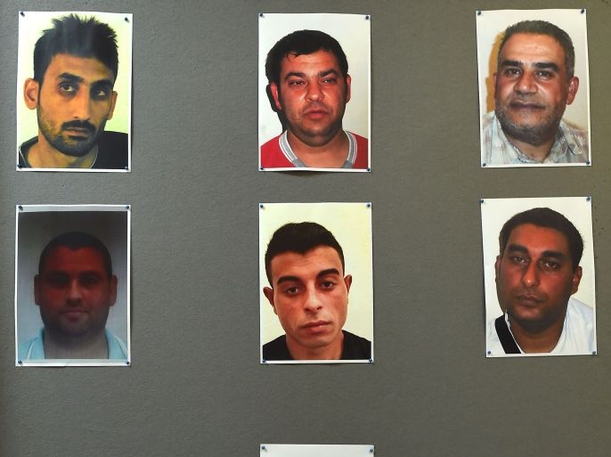JK1044 - Eisenstadt, -, AUSTRIA : A barcode link is displayed under the pictures of suspected human traffickers arrested over the death of 71 refugees found in an abandoned refrigerated truck on an Austrian highway near the Hungary border on August 27, 2015, during a press conference at the Burgenland's police headquarters in Eisenstadt, Austria on September 4, 2015 to inform on their investigation on the gruesome discovery.