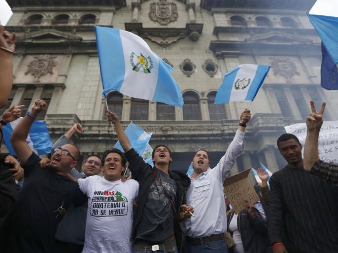 Demonstrators wave Guatemalan flags as they celebrate that Congress voted to withdraw President Otto Perez Molina's immunity from prosecution, in Guatemala City, Tuesday, Sep. 1, 2015. Perez Molina's government has been beset by a series of corruption cases, but until now he has been immune to prosecution as president. (AP Photo Moises Castillo)