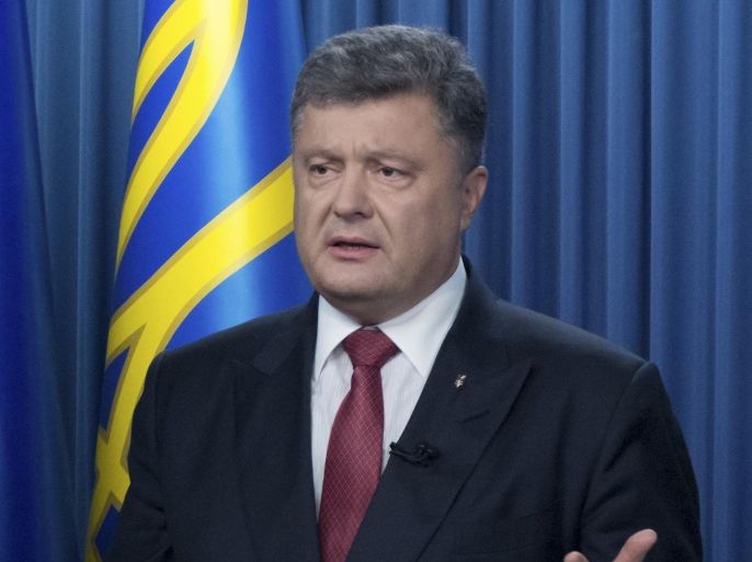 Ukraine's President Petro Poroshenko addresses to the nation in Kiev, Ukraine, Monday, Aug. 31, 2015. The Ukrainian parliament has given preliminary approval to a controversial constitutional amendment that would provide greater powers to separatist regions in the east. Hundreds of people gathered in front of the parliament to protest against the amendment. A policeman died and more than 100 people were injured in clashes with protesters. (AP Photo/Mykhailo Markiv, Pool)