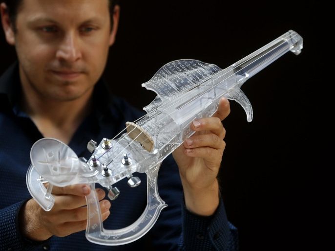 French engineer and professional violinist Laurent Bernadac poses with the "3Dvarius", a 3D printed violin made of transparent resin, during an interview with Reuters in Paris, France, September 11, 2015. REUTERS/Christian Hartmann