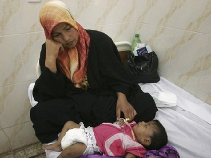 An Iraqi woman comforts her child, who health officials suspect is infected with cholera, at a hospital in Hashimiyah, 80 kilometers (50 miles) south of Baghdad, Iraq on Wednesday, Sept. 10, 2008. Iraqi officials say the number of people killed by a cholera outbreak in Iraq has risen to two and that the waterborne disease has infected at least 90 people.