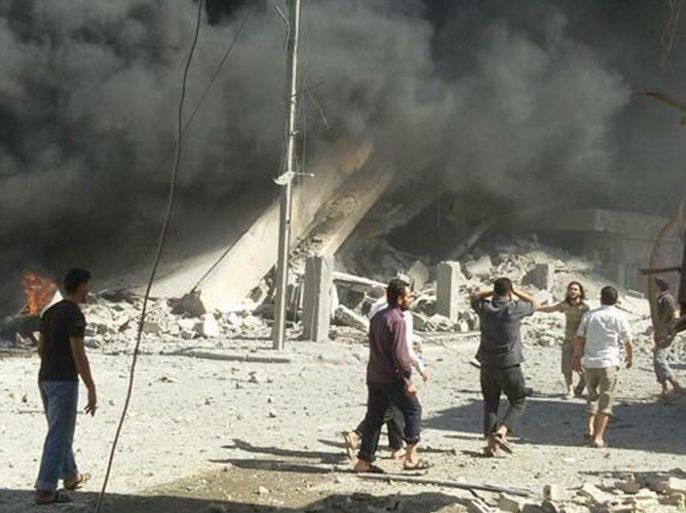 This image taken in Wednesday, Sept. 30, 2015 posted on the Twitter account of Syria Civil Defence, also known as the White Helmets, a volunteer search and rescue group, shows the aftermath of an airstrike in Talbiseh, Syria. Russia on Wednesday carried out its first airstrikes in Syria in what President Vladimir Putin called a pre-emptive strike against the militants. Khaled Khoja, head of the Syrian National Council opposition group, said at the U.N. that Russian airstrikes in four areas, including Talbiseh, killed dozens of civilians, with children among the dead. (Syria Civil Defence via AP)