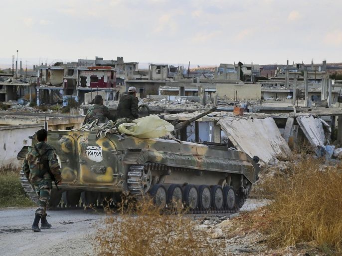 In this photo taken on Wednesday, Oct. 7, 2015, a Syrian army armored vehicle moves near the village of Morek in Syria. The Syrian army has launched an offensive this week in central and northwestern Syria aided by Russian airstrikes. (AP Photo/Alexander Kots, Komsomolskaya Pravda, Photo via AP)